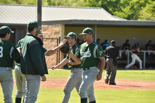 Sophomore pitcher Kyle Rogers being congratulated by his teammates for a good performance.